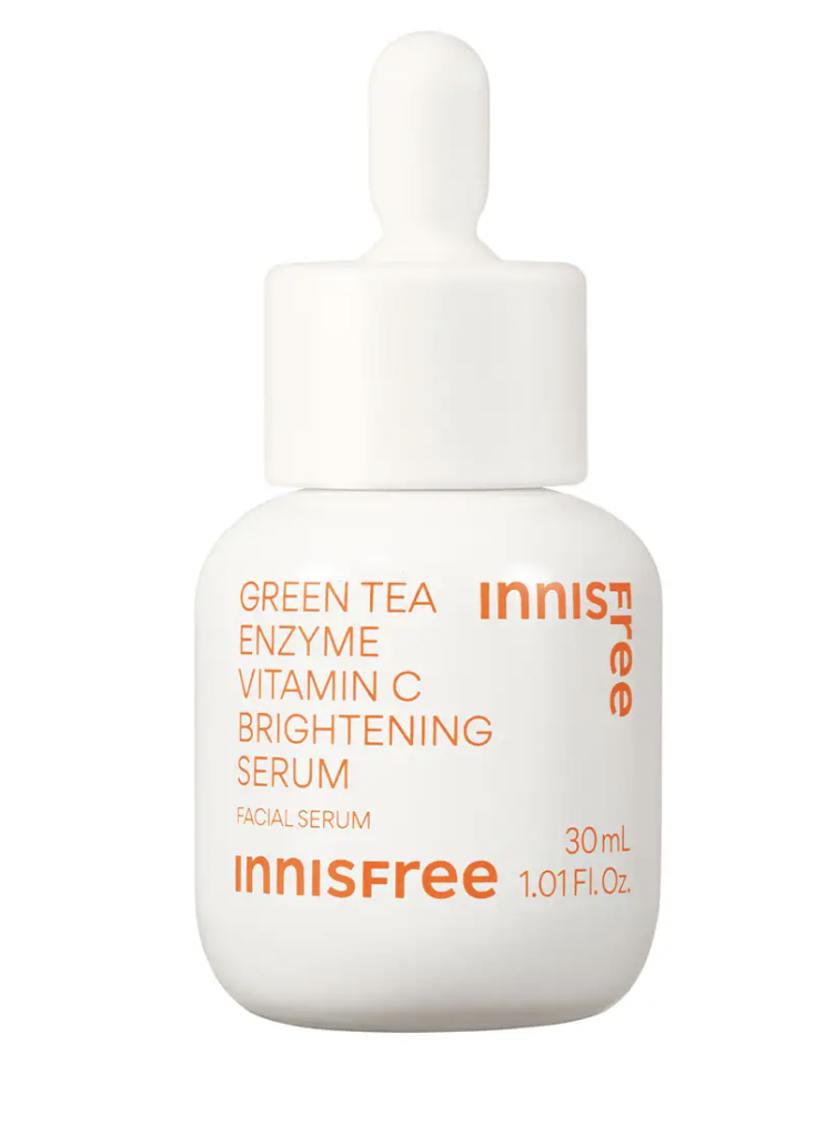 A white dropper bottle with orange text highlighting its key ingredients, vitamin C and green tea enzymes, aimed at brightening the complexion. The bottle contains 30ml of serum.